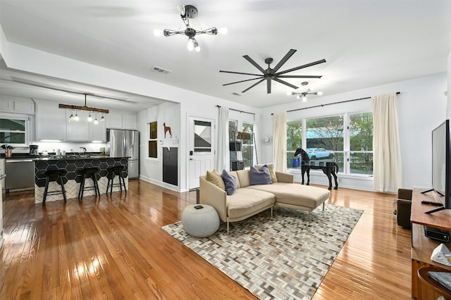 living room featuring an inviting chandelier and hardwood / wood-style flooring