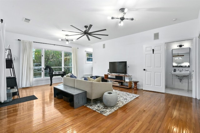 living room with sink and light hardwood / wood-style floors