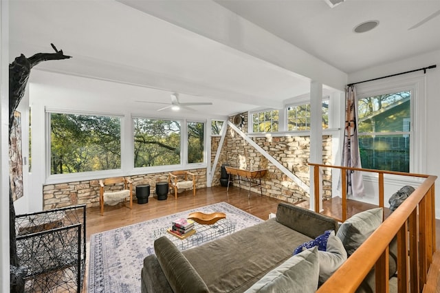 sunroom / solarium with a healthy amount of sunlight and ceiling fan