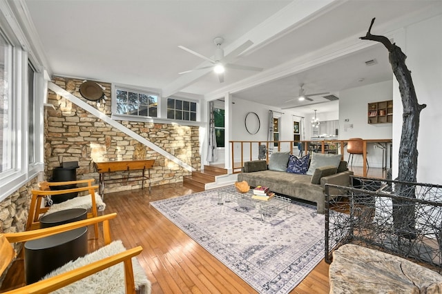 living room with hardwood / wood-style floors, ceiling fan with notable chandelier, and ornamental molding