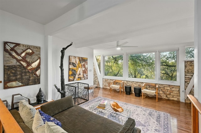 living room featuring ceiling fan, beam ceiling, hardwood / wood-style floors, and a wealth of natural light