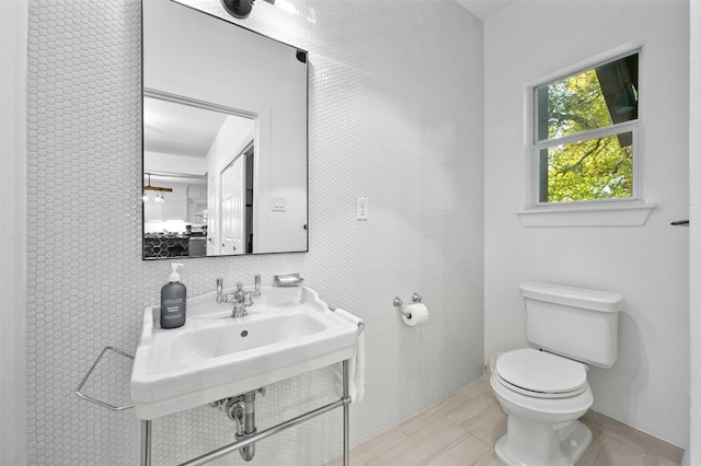 bathroom featuring sink, tile patterned floors, and toilet