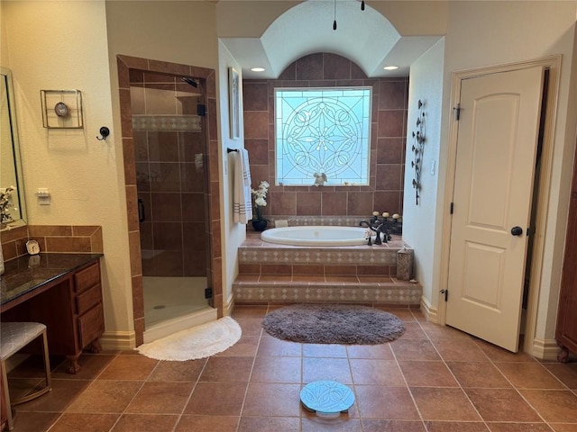 bathroom with tile patterned flooring, vanity, and independent shower and bath