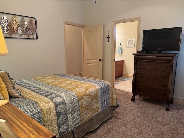 carpeted bedroom with ensuite bath