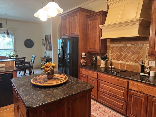 kitchen with premium range hood, decorative light fixtures, a kitchen island, decorative backsplash, and black appliances