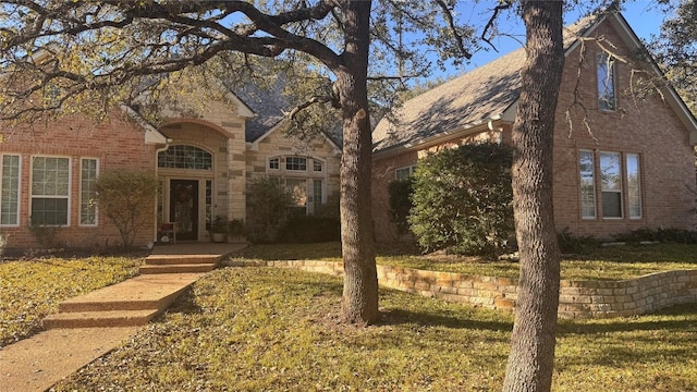 tudor-style house with a front yard