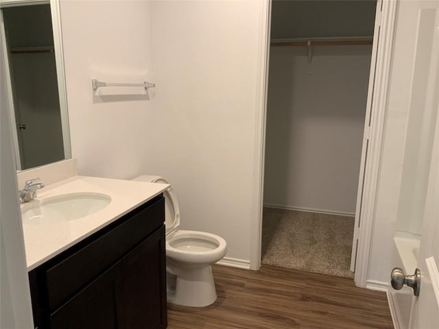 155 Citrine Crst, Maxwell, TX 78656 - full bathroom with vanity, wood finished floors, a walk in closet, and a bathtub