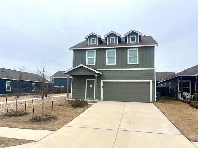 155 Citrine Crst, Maxwell, TX 78656 - view of front of property with an attached garage, board and batten siding, and concrete driveway
