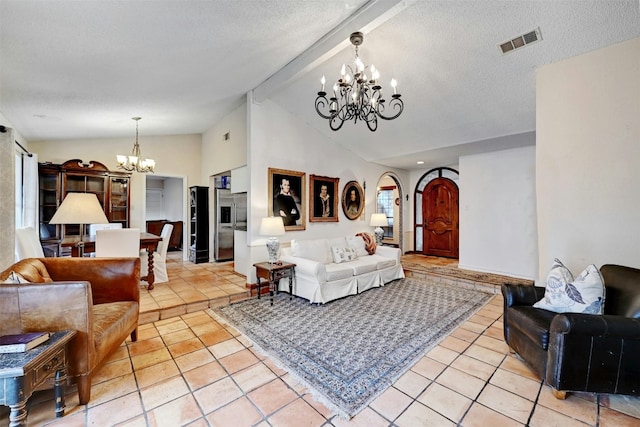 living room with vaulted ceiling with beams, light tile patterned floors, a notable chandelier, and a textured ceiling