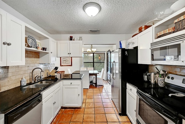 107 S Cuernavaca Dr, Austin, TX 78733 - kitchen featuring stainless steel appliances, open shelves, white cabinetry, and a textured ceiling