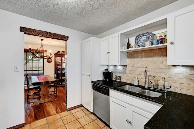 kitchen featuring a sink, white cabinets, stainless steel dishwasher, open shelves, and tasteful backsplash