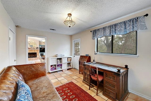 107 S Cuernavaca Dr, Austin, TX 78733 - home office with a fireplace, a textured ceiling, and light tile patterned floors