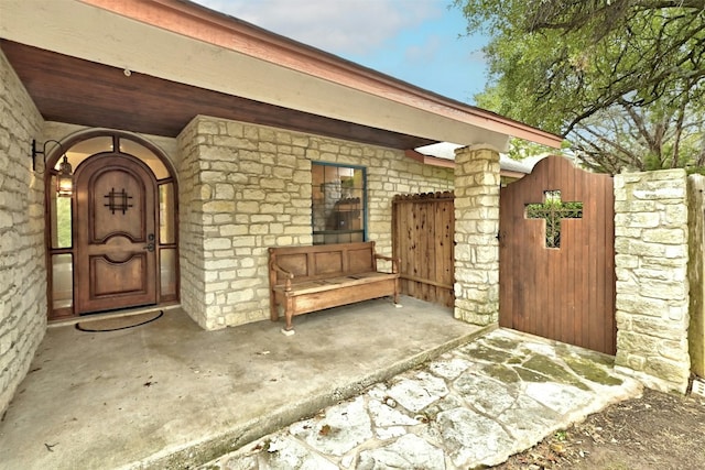 107 S Cuernavaca Dr, Austin, TX 78733 - view of exterior entry featuring a gate and stone siding