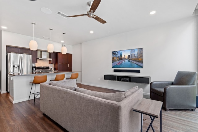 living room with ceiling fan and dark hardwood / wood-style floors