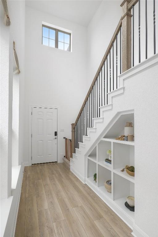 821 Olinda Way, Liberty Hill, TX 78642 - foyer entrance featuring a towering ceiling, wood finished floors, and stairway