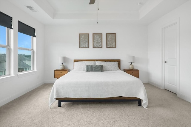821 Olinda Way, Liberty Hill, TX 78642 - bedroom featuring a tray ceiling, light carpet, a ceiling fan, and crown molding