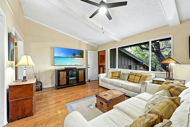 living room with ceiling fan, light hardwood / wood-style flooring, lofted ceiling with beams, and a textured ceiling