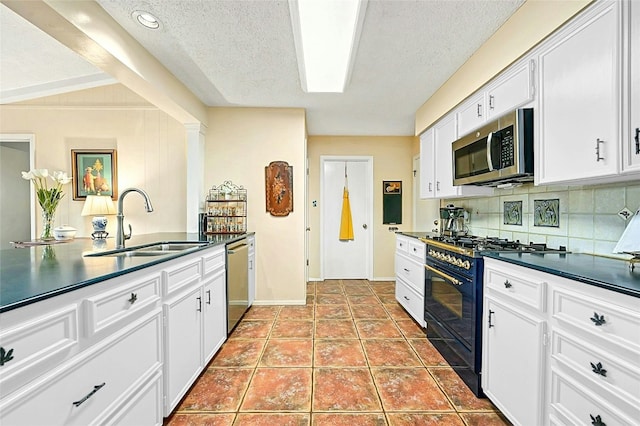 kitchen featuring sink, white cabinetry, stainless steel appliances, tile patterned flooring, and backsplash