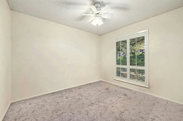 empty room featuring ceiling fan, carpet floors, and a textured ceiling