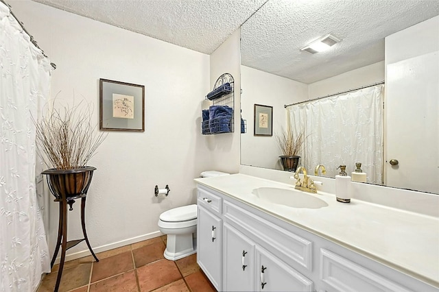 bathroom with vanity, tile patterned flooring, a textured ceiling, and toilet