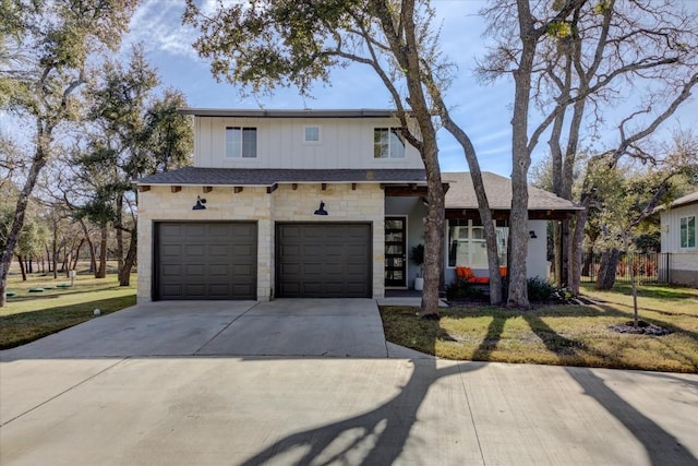 view of front of home with a garage and a front yard