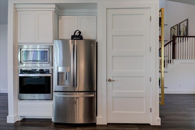 kitchen with white cabinetry, dark wood-type flooring, and stainless steel appliances