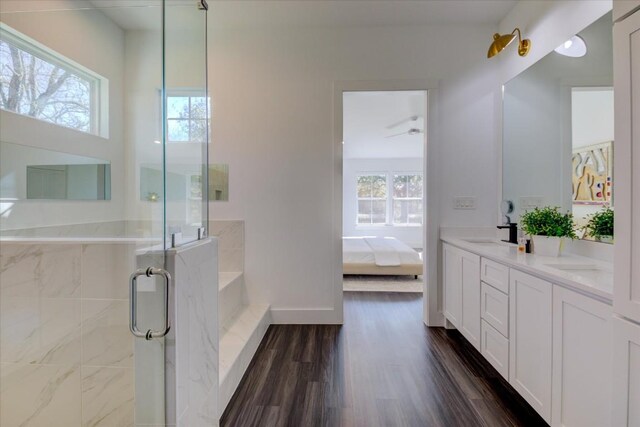 bathroom featuring walk in shower, vanity, and hardwood / wood-style floors