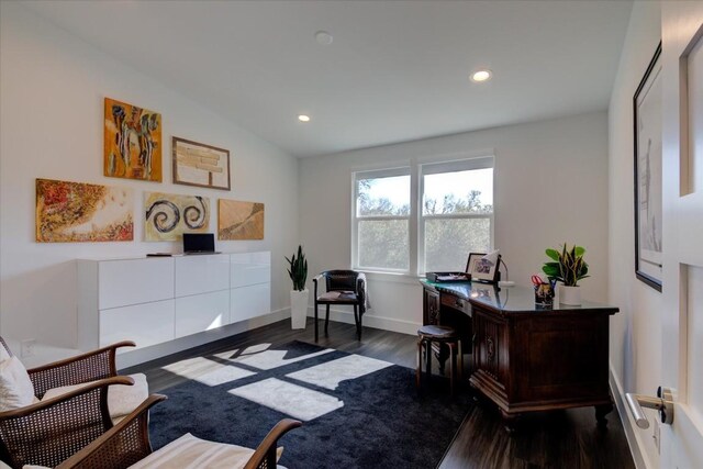 office area with dark wood-type flooring and vaulted ceiling