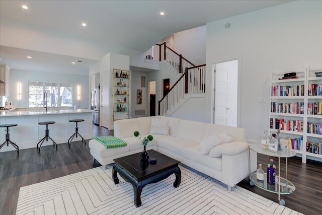 living room with sink and hardwood / wood-style floors