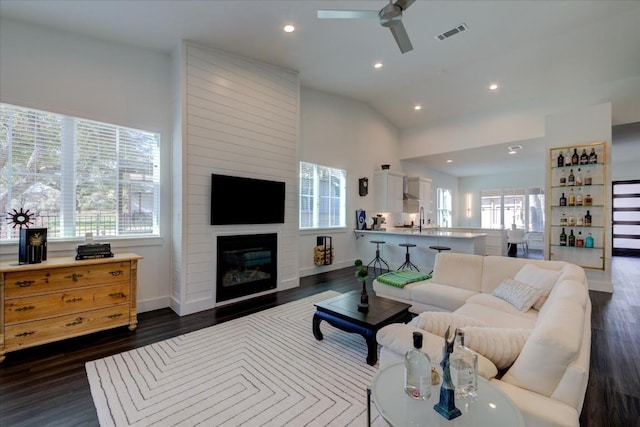 living room featuring ceiling fan, a fireplace, lofted ceiling, and dark hardwood / wood-style floors