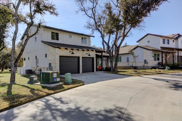 modern farmhouse style home with a garage, central AC unit, and a front lawn