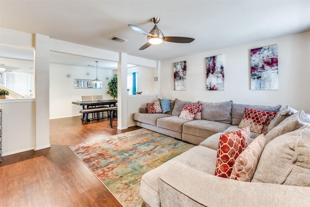 living room featuring ceiling fan and hardwood / wood-style floors