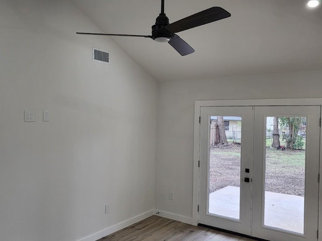 doorway to outside with vaulted ceiling, ceiling fan, light wood-type flooring, and french doors