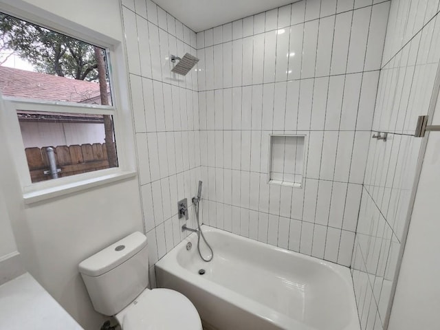 bathroom with tiled shower / bath combo and toilet