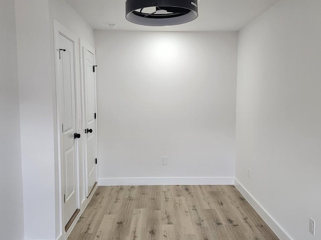 empty room with light hardwood / wood-style flooring