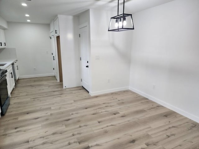 unfurnished dining area with light hardwood / wood-style flooring