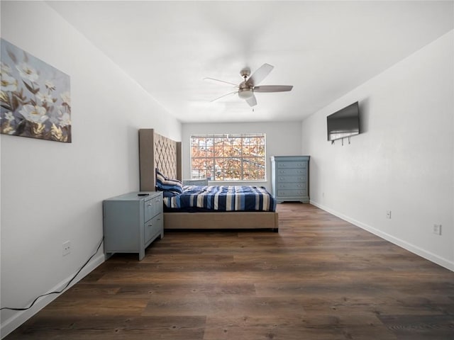 unfurnished bedroom featuring ceiling fan and dark hardwood / wood-style flooring