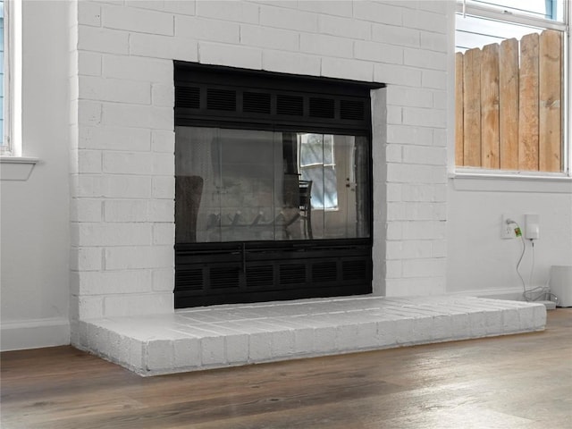 details with hardwood / wood-style flooring and a fireplace