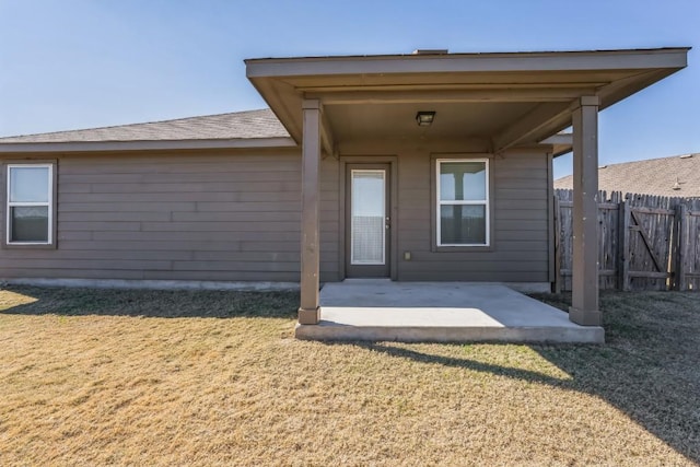 doorway to property featuring a yard and a patio