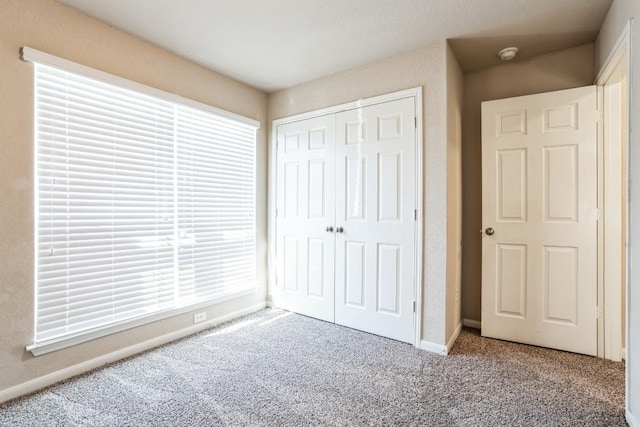 unfurnished bedroom with carpet and a closet