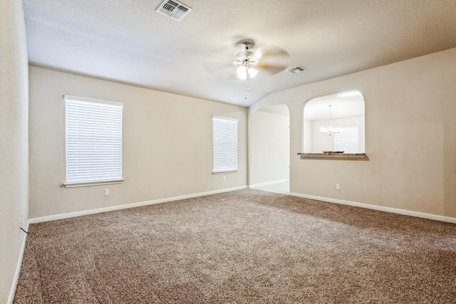 empty room with carpet floors and ceiling fan with notable chandelier