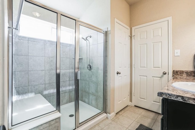 bathroom with tile patterned flooring, vanity, and an enclosed shower