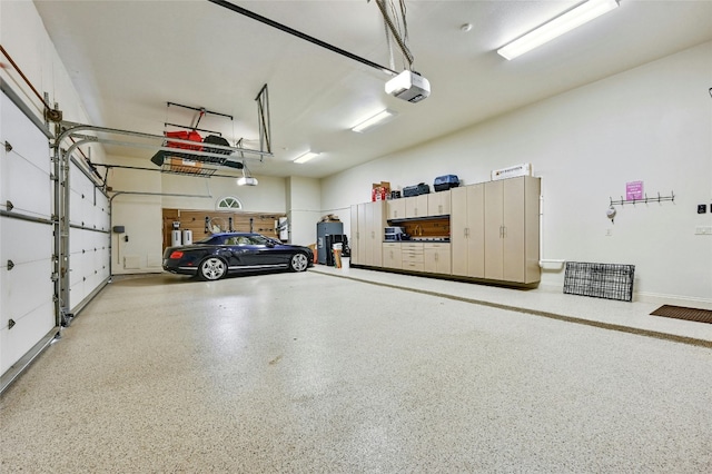 garage with a garage door opener and electric water heater