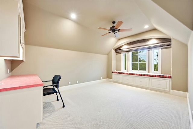 carpeted home office with lofted ceiling and ceiling fan