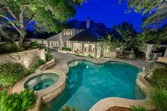 view of pool with a patio and an in ground hot tub