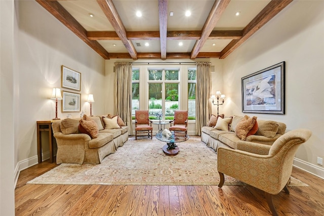 living room featuring beamed ceiling, coffered ceiling, and light hardwood / wood-style flooring