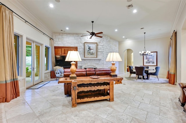 living room with crown molding and ceiling fan with notable chandelier