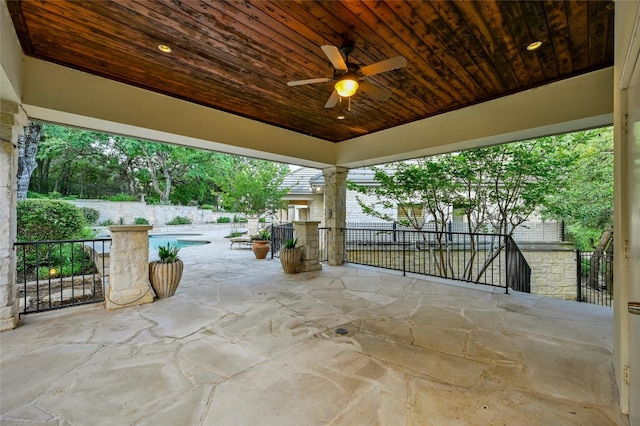 view of patio / terrace with ceiling fan and a fenced in pool