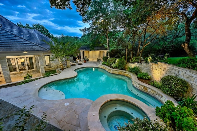 view of pool with an in ground hot tub and a patio area