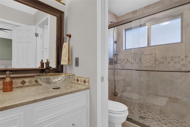 bathroom featuring vanity, an enclosed shower, and toilet